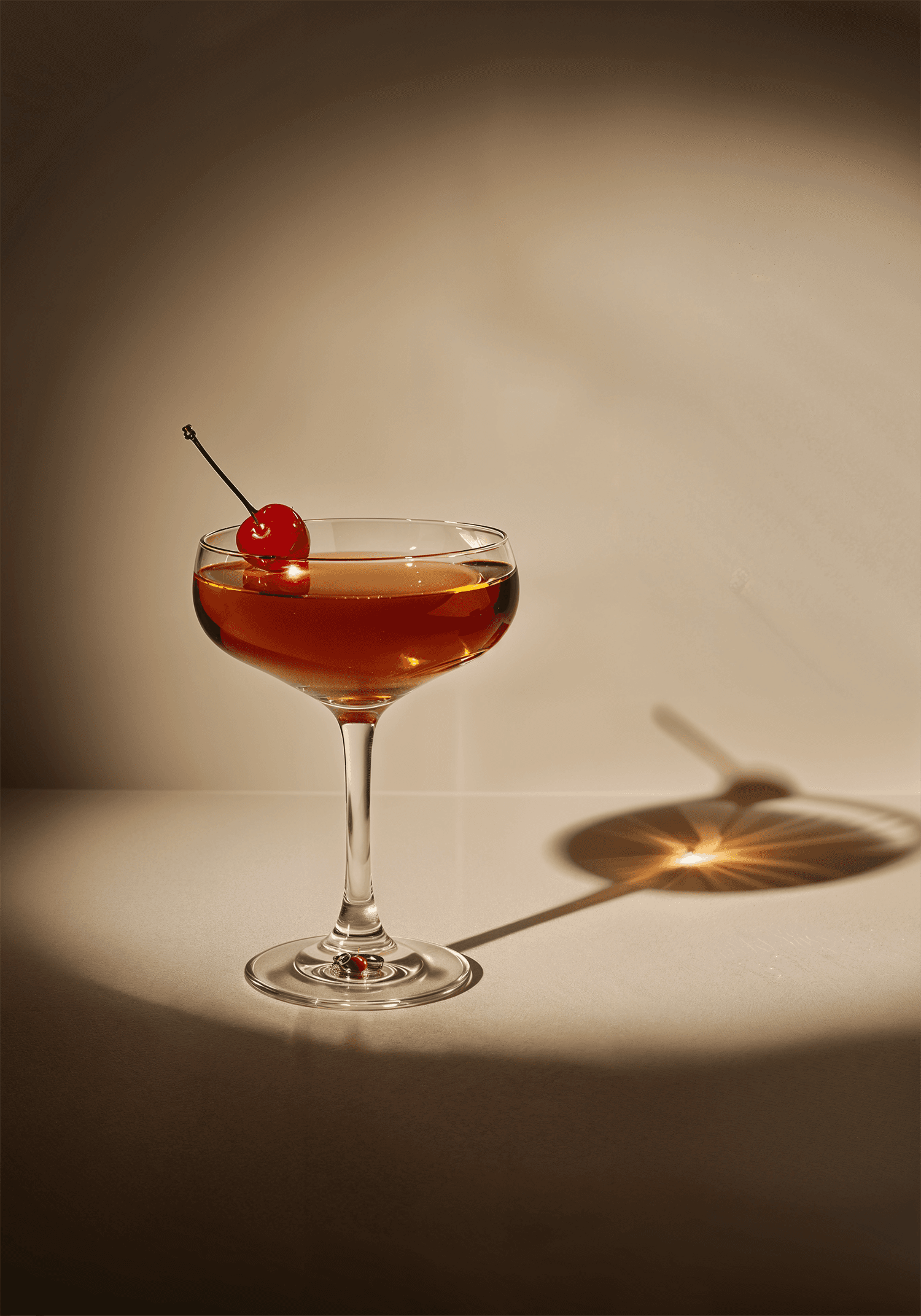 a cocktail glass with a cherry